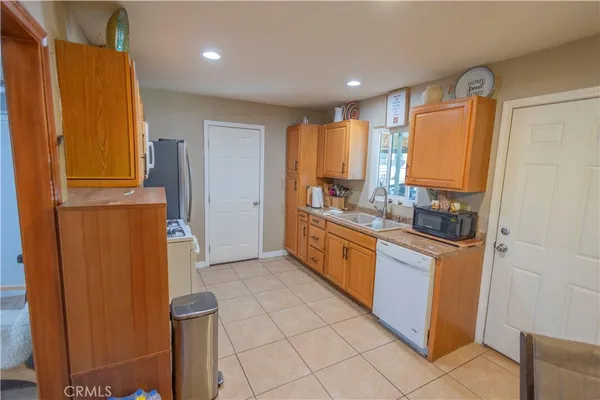 a kitchen with stainless steel appliances granite countertop a refrigerator and a stove