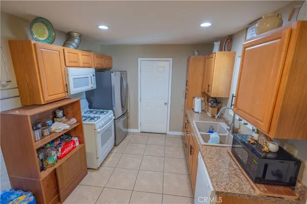 a kitchen with stainless steel appliances granite countertop a refrigerator and a stove