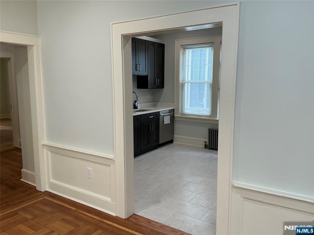 a view of a hallway and an dining rom with furniture