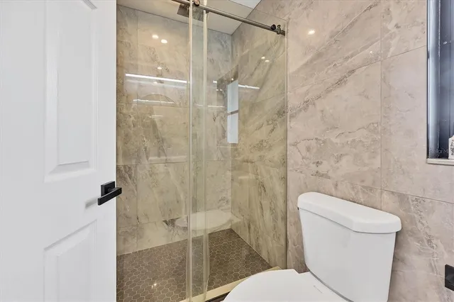 a bathroom with a toilet and shower