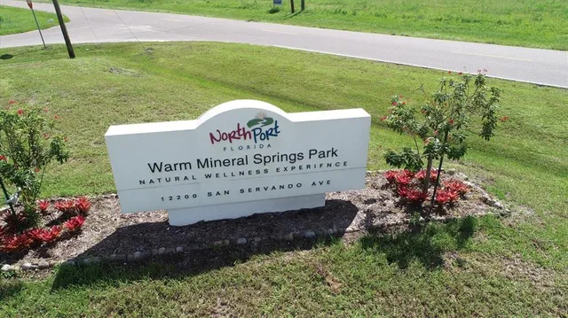 an aerial view of a golf course with swimming pool and outdoor seating