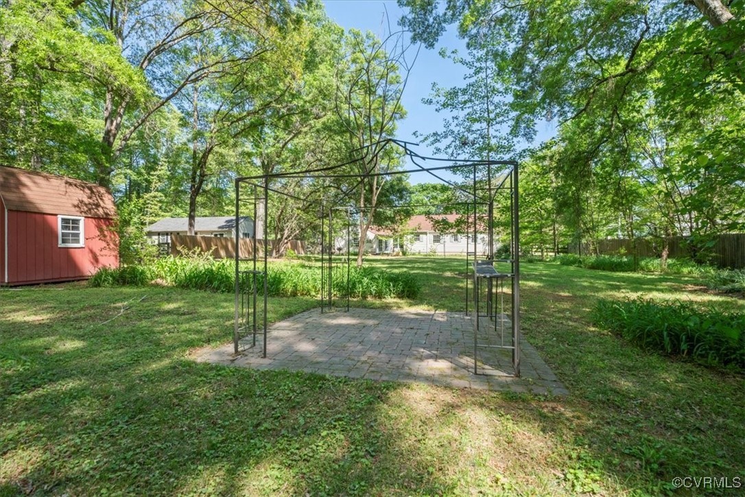 10308 Purcell Road Henrico, VA 23228 - Photo 33 of 36 View of yard featuring fence, a storage unit, a pa