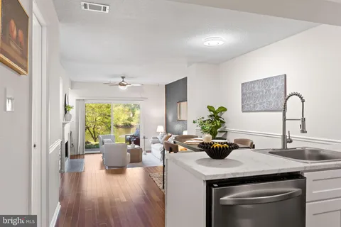 a kitchen with a refrigerator a stove and a sink