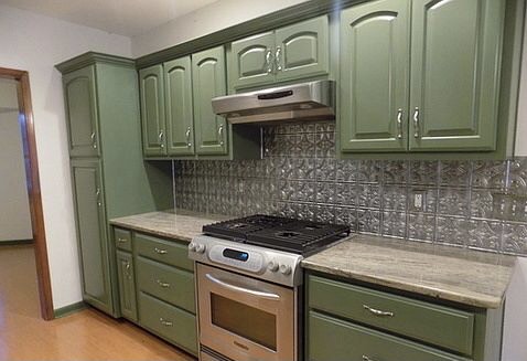 509 Meadowbrook Drive Georgetown, TX 78628 - Photo 4 of 17 Green cabinetry and sleek appliances elevate this functional and inviting kitchen space.