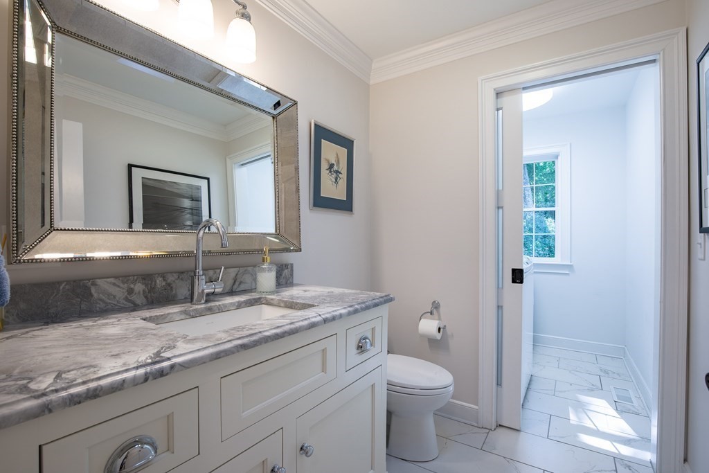 671 Salem End Road Framingham, MA 01702 - Photo 16 of 41 a bathroom with a granite countertop toilet sink and mirror