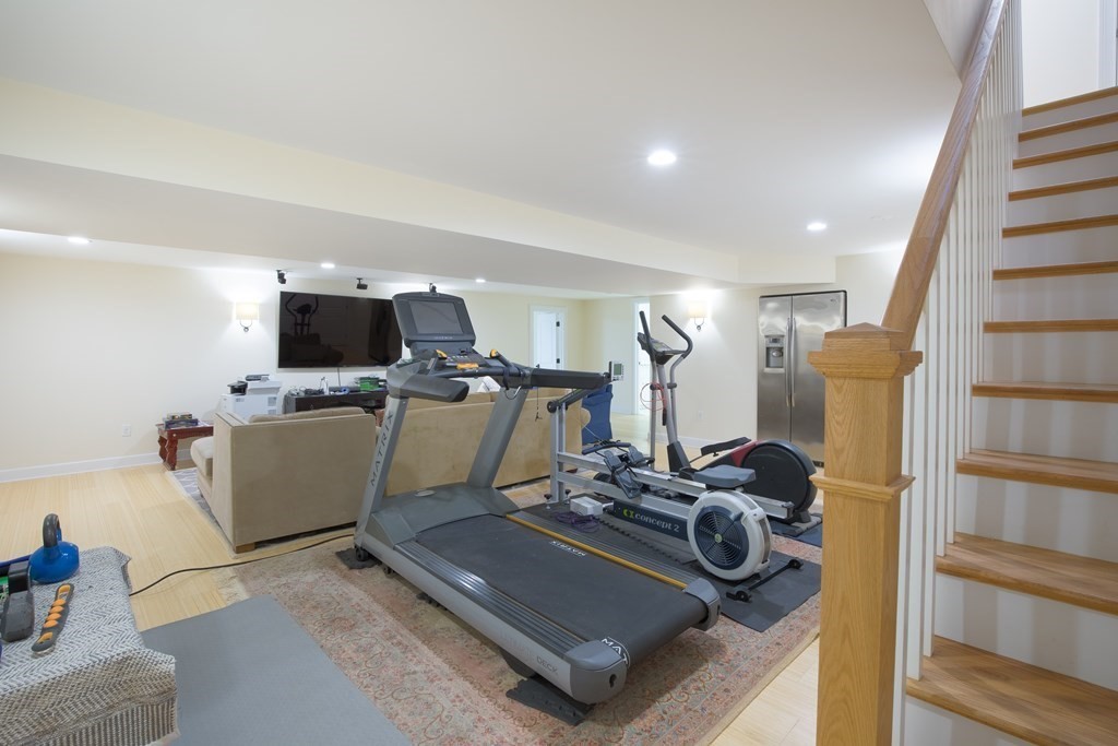 671 Salem End Road Framingham, MA 01702 - Photo 24 of 41 a room with furniture a flat screen tv and a fireplace