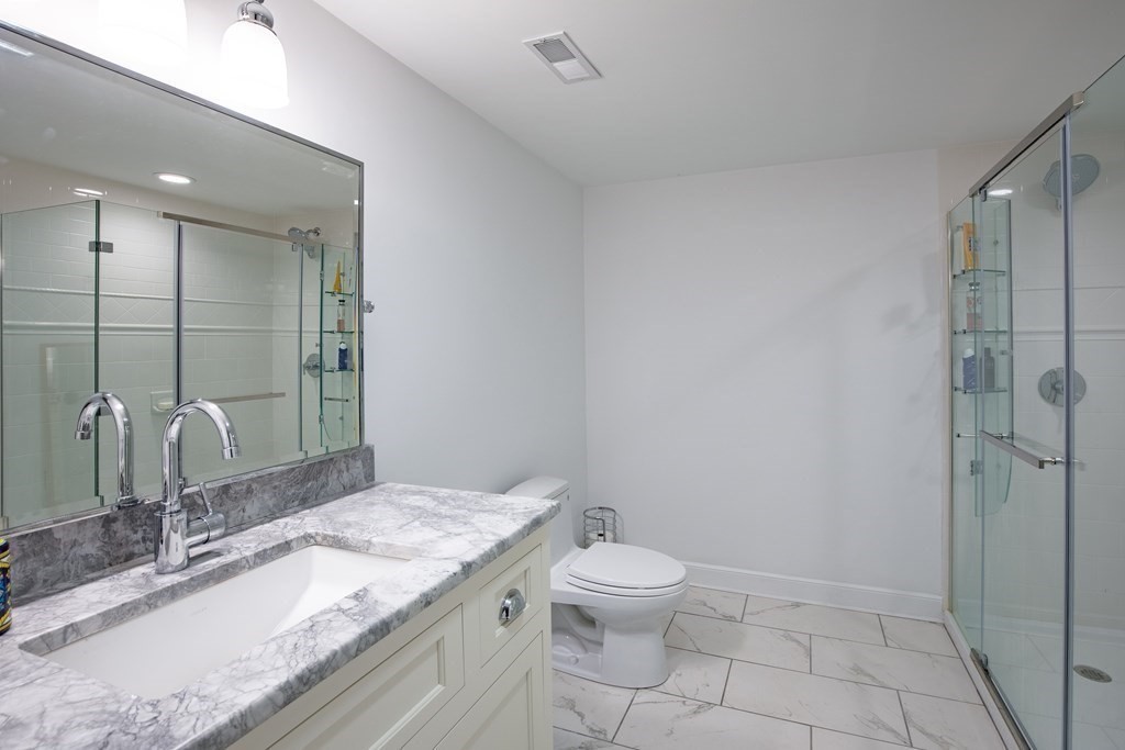 671 Salem End Road Framingham, MA 01702 - Photo 26 of 41 a bathroom with a granite countertop sink a toilet and shower
