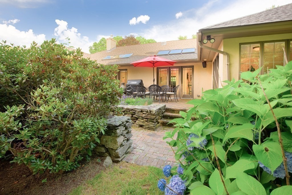 671 Salem End Road Framingham, MA 01702 - Photo 31 of 41 a view of a patio with table and chairs and potted plants