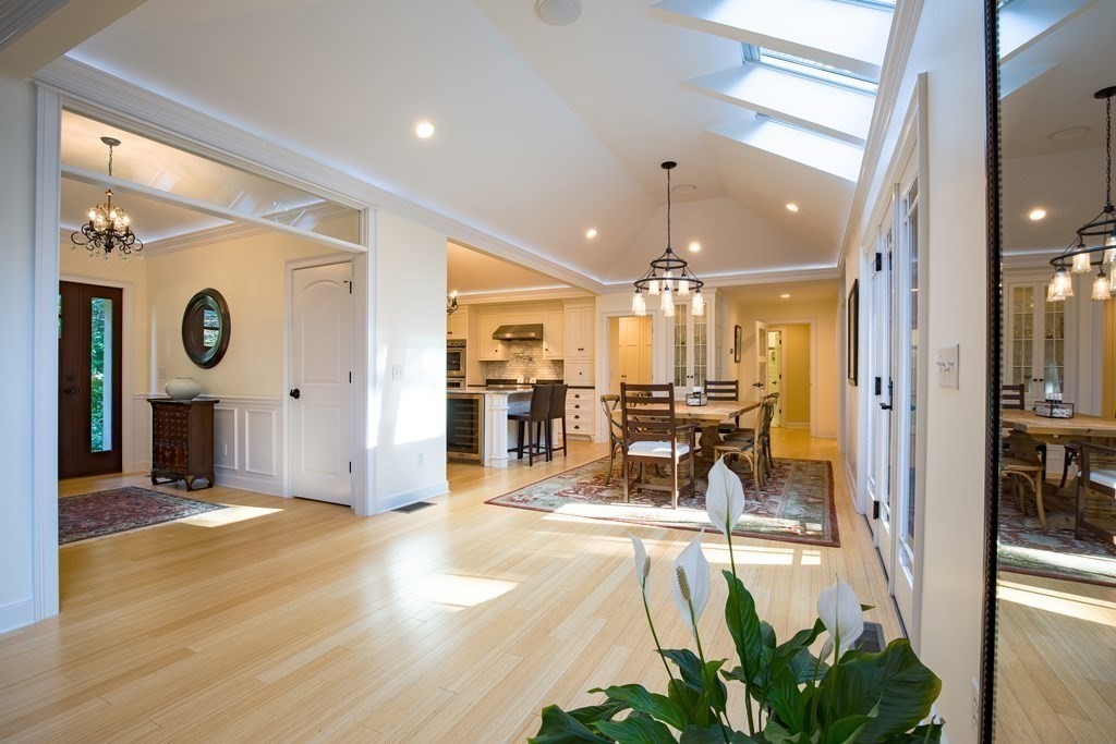 671 Salem End Road Framingham, MA 01702 - Photo 6 of 41 a view of a hallway with dining area and chandelier