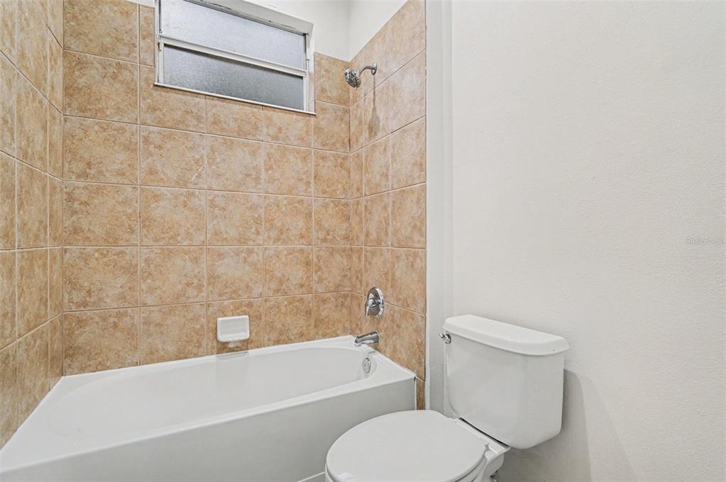 4819 Indian Deer Road Windermere, FL 34786 - Photo 29 of 30 a bathroom with a toilet and a bath tub