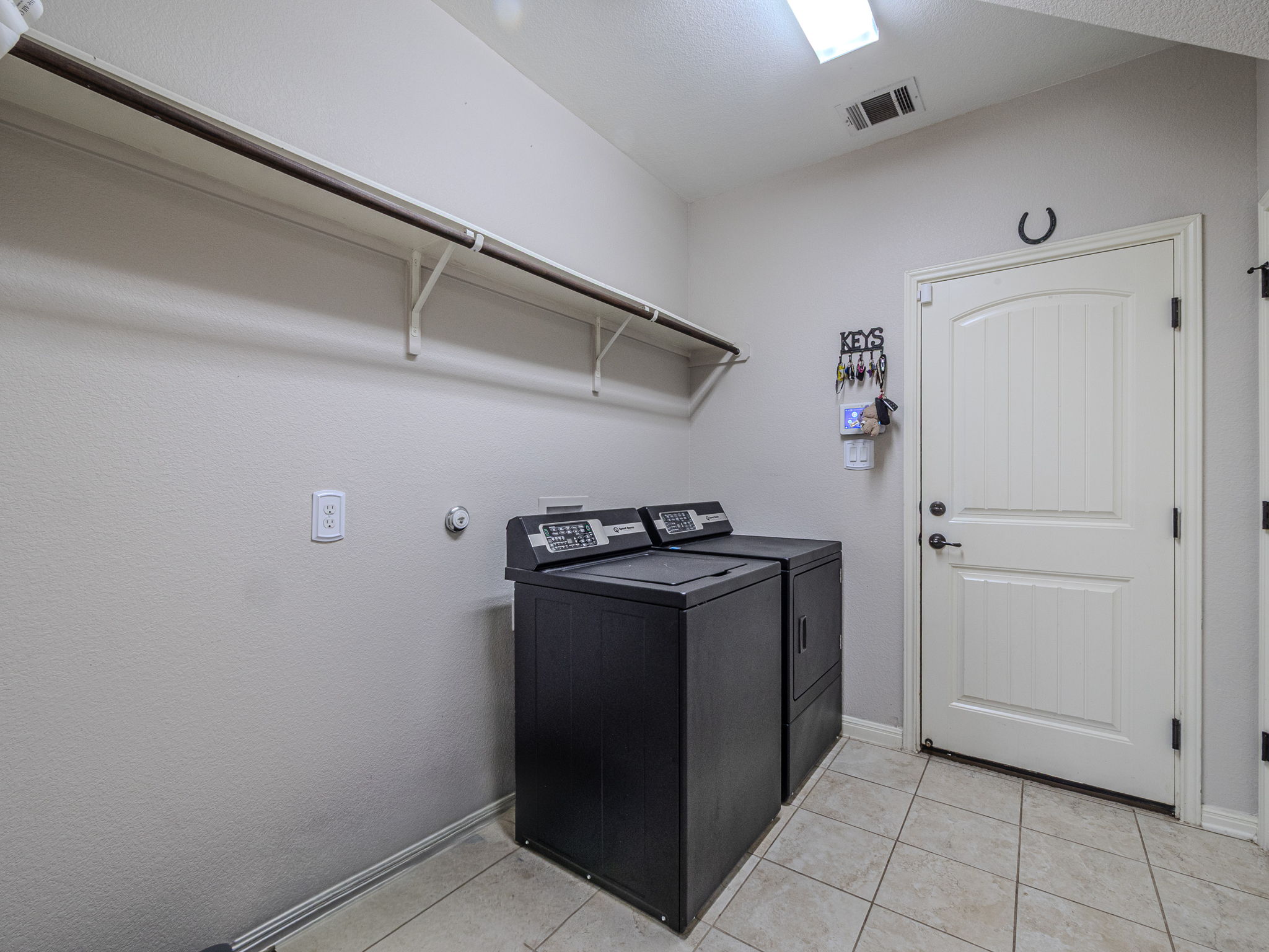 117 Arbor Point Drive Elgin, TX 78621 - Photo 30 of 40 Laundry area featuring baseboards and light tile patterned floors