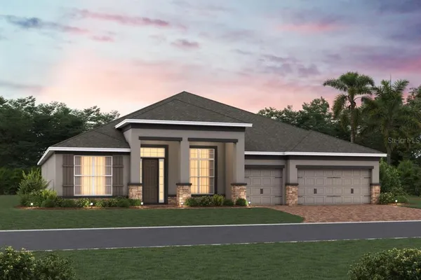 a front view of a house with a yard and trees