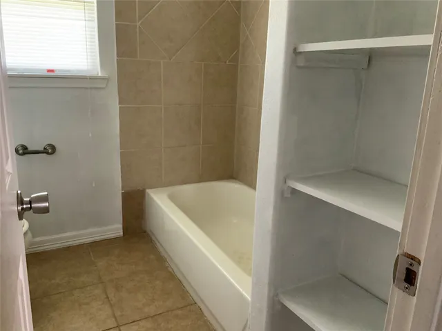 a bathroom with a bathtub and shower