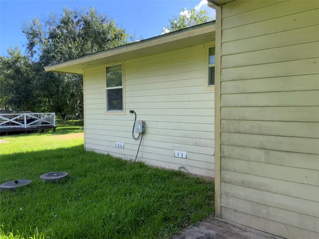 a view of a backyard with plants and a patio