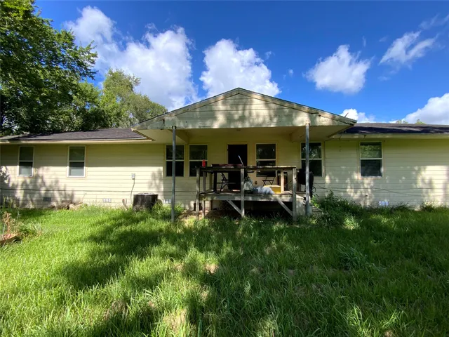 a backyard of a house with table and chairs
