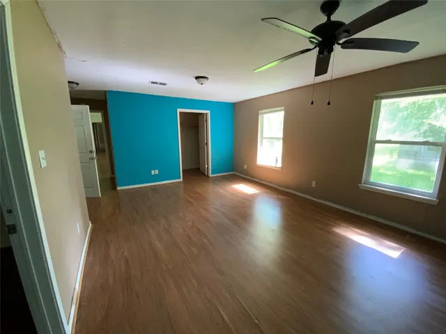 wooden floor in an empty room with a window