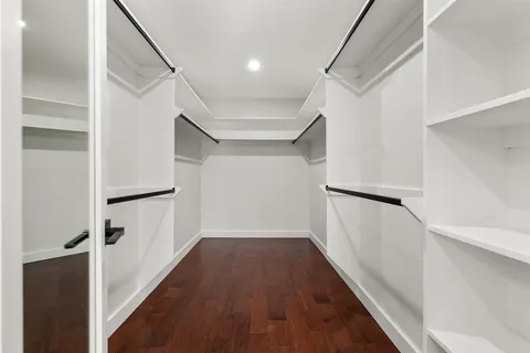 a view of hallway with wooden floor and front door