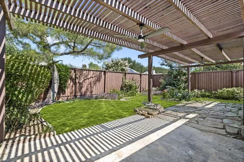 a view of a backyard with sitting area