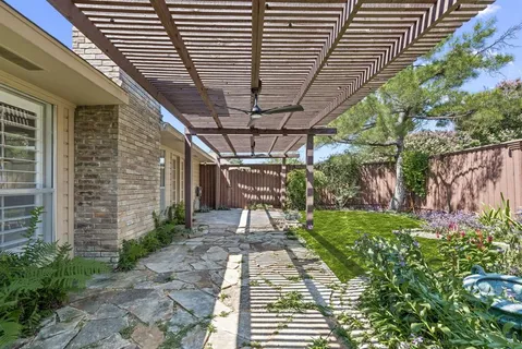 a view of a patio with a table and chairs next to a yard