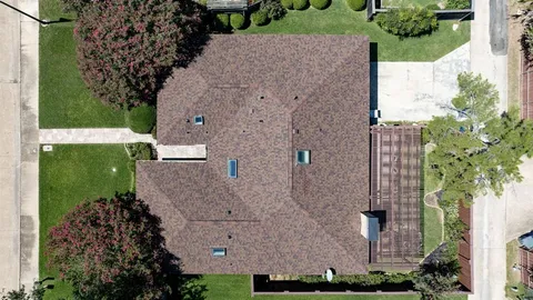 an aerial view of a house with a yard