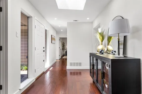 a view of hallway with wooden floor