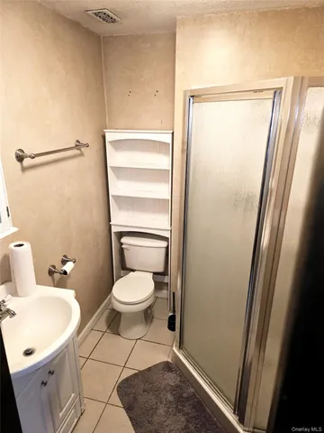 a bathroom with a toilet a sink and a shower