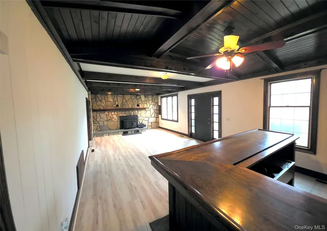 a view of empty room with wooden floor and fireplace