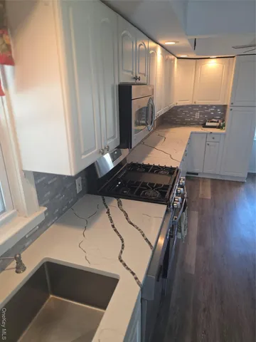 a view of a bedroom with wooden floor and windows