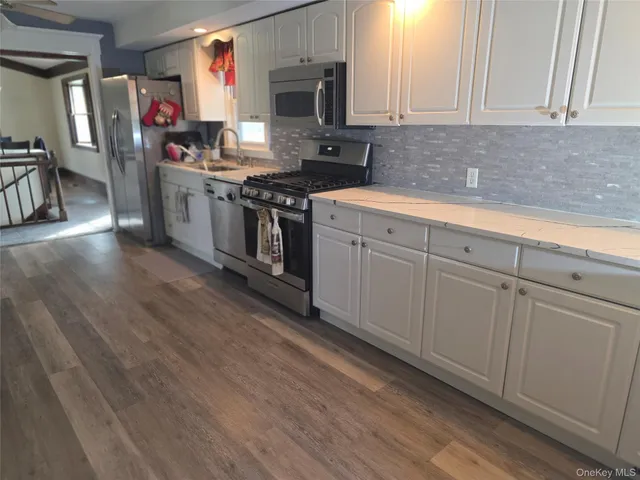 a view of entryway and hall with wooden floor