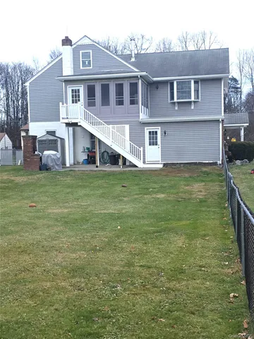 a large house with a big yard and large trees