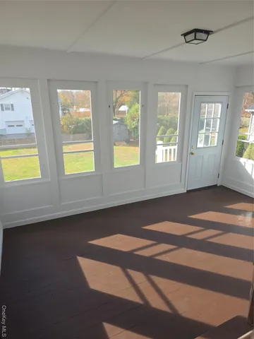 a view of an empty room with windows