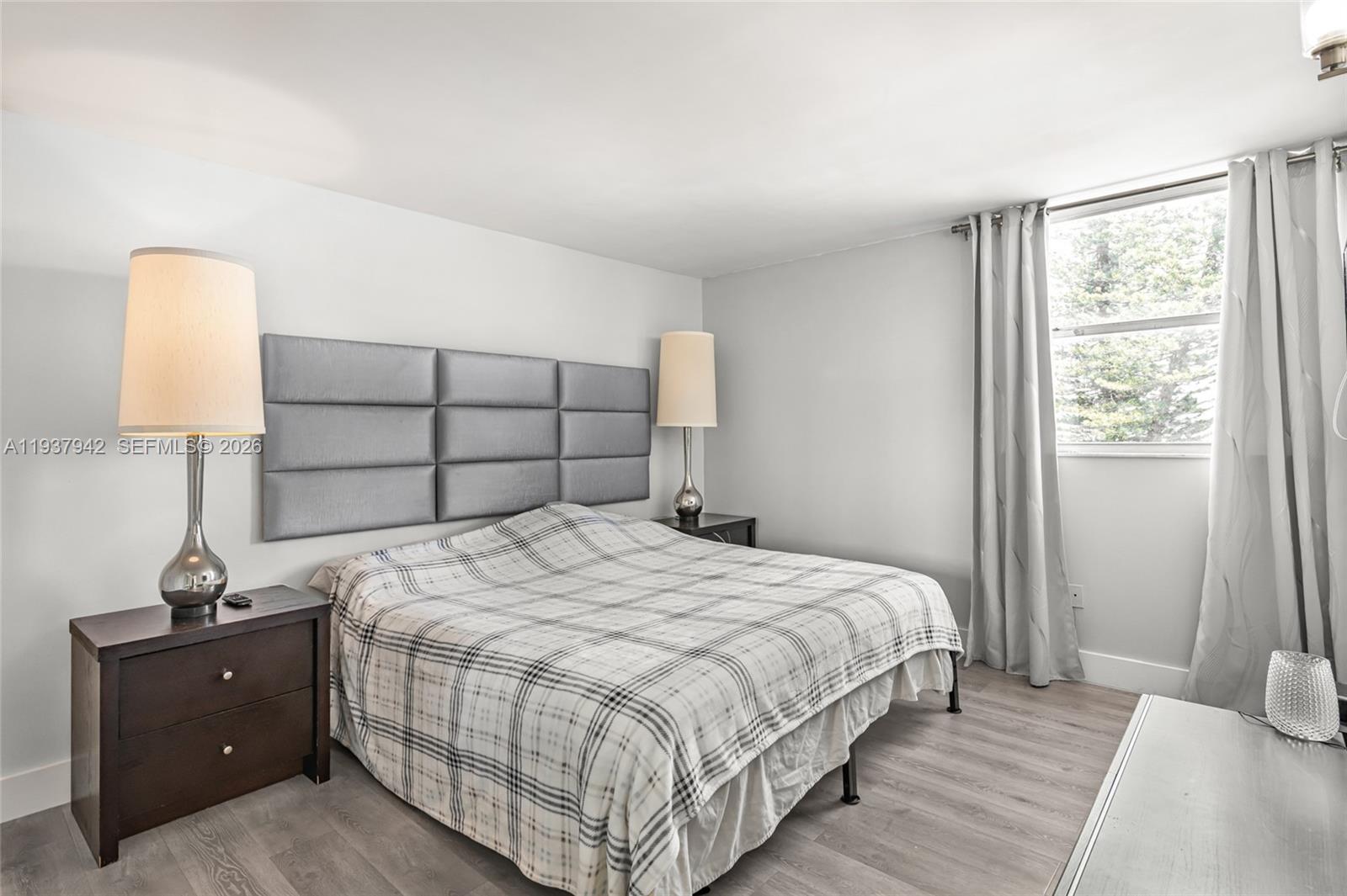 1250 Alton Road, Unit 3A Miami Beach, FL 33139 - Photo 12 of 25 a bedroom with a bed and a window