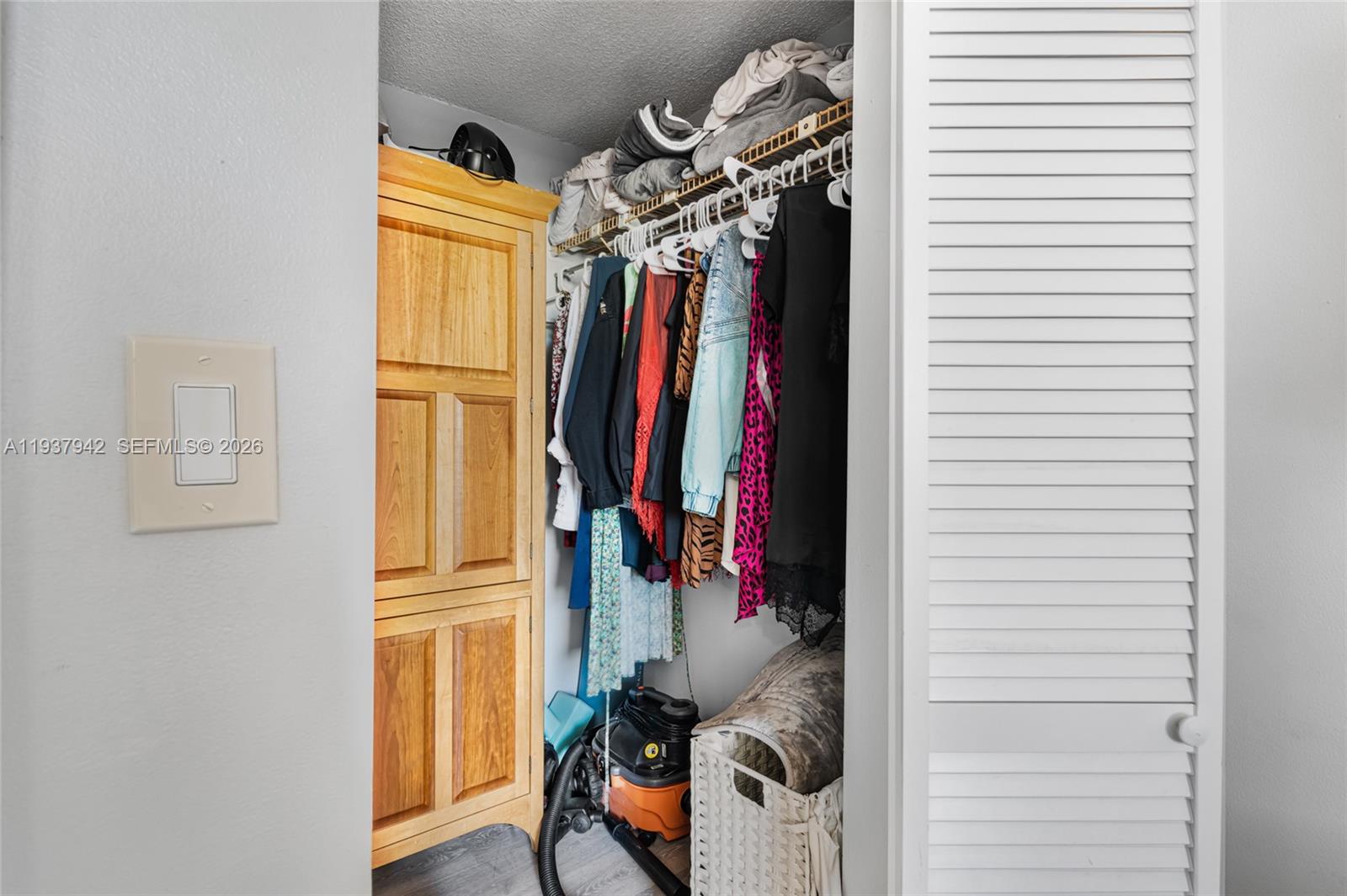 1250 Alton Road, Unit 3A Miami Beach, FL 33139 - Photo 13 of 25 a view of walk in closet with clothes and shoes