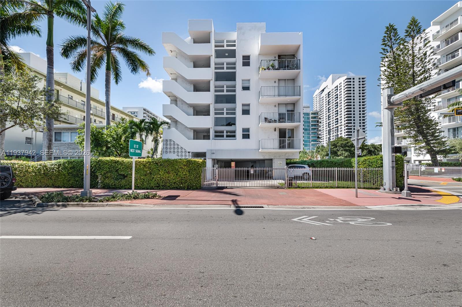 1250 Alton Road, Unit 3A Miami Beach, FL 33139 - Photo 25 of 25 a front view of multi story residential apartment building with yard and tress