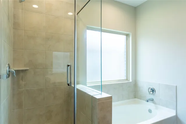 a bathroom with a bathtub and a shower