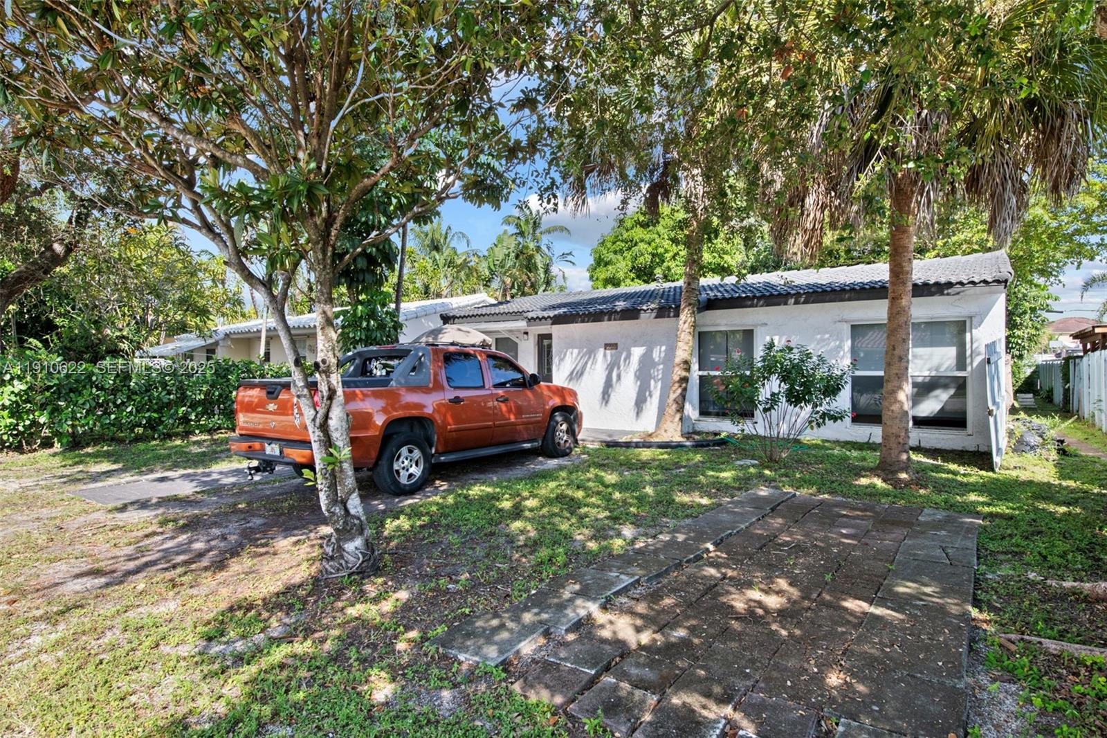 a view of a house with a yard and sitting area