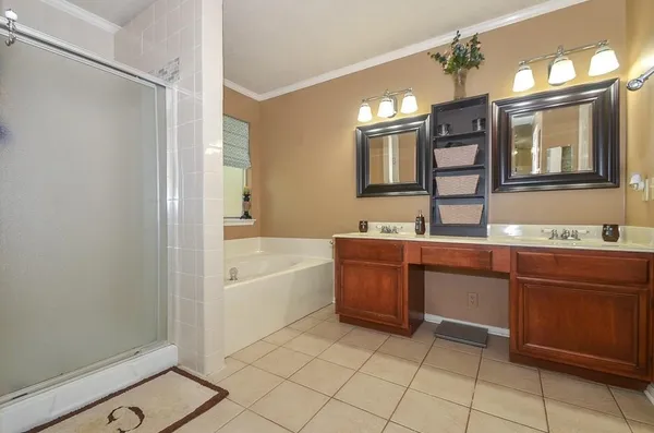 a bathroom with a tub sink and mirror