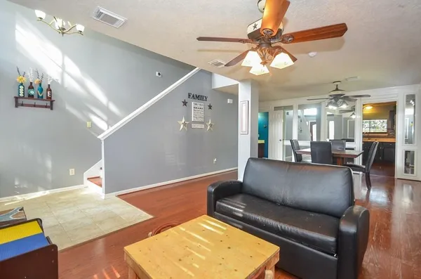 a living room with furniture and a chandelier