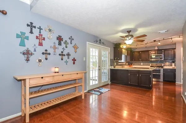 a kitchen with stainless steel appliances kitchen island granite countertop a refrigerator and a stove top oven