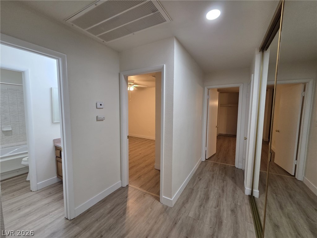 3317 Racquet Street Las Vegas, NV 89121 - Photo 4 of 23 Hallway leading to several rooms, featuring sleek flooring and functional design.