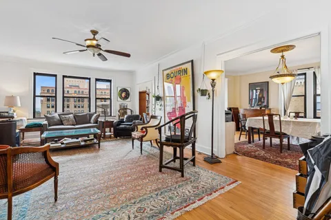 a living room with furniture a rug and a window