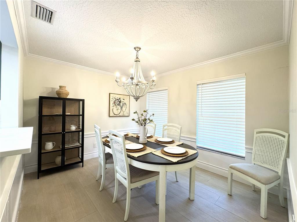 1004 Southeast 5th Avenue Crystal River, FL 34429 - Photo 16 of 43 a view of a dining room with furniture and chandelier