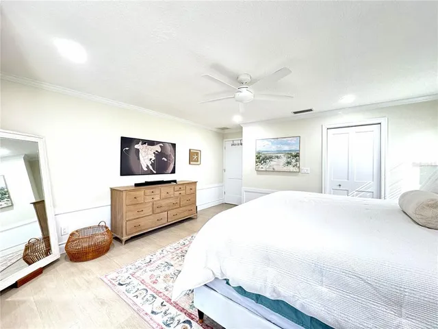 a bedroom with a bed and a large window with outer view