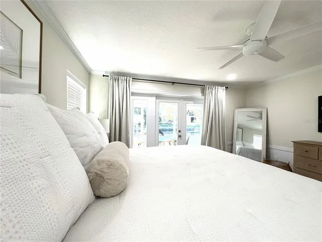 a bedroom with a large bed and a large window