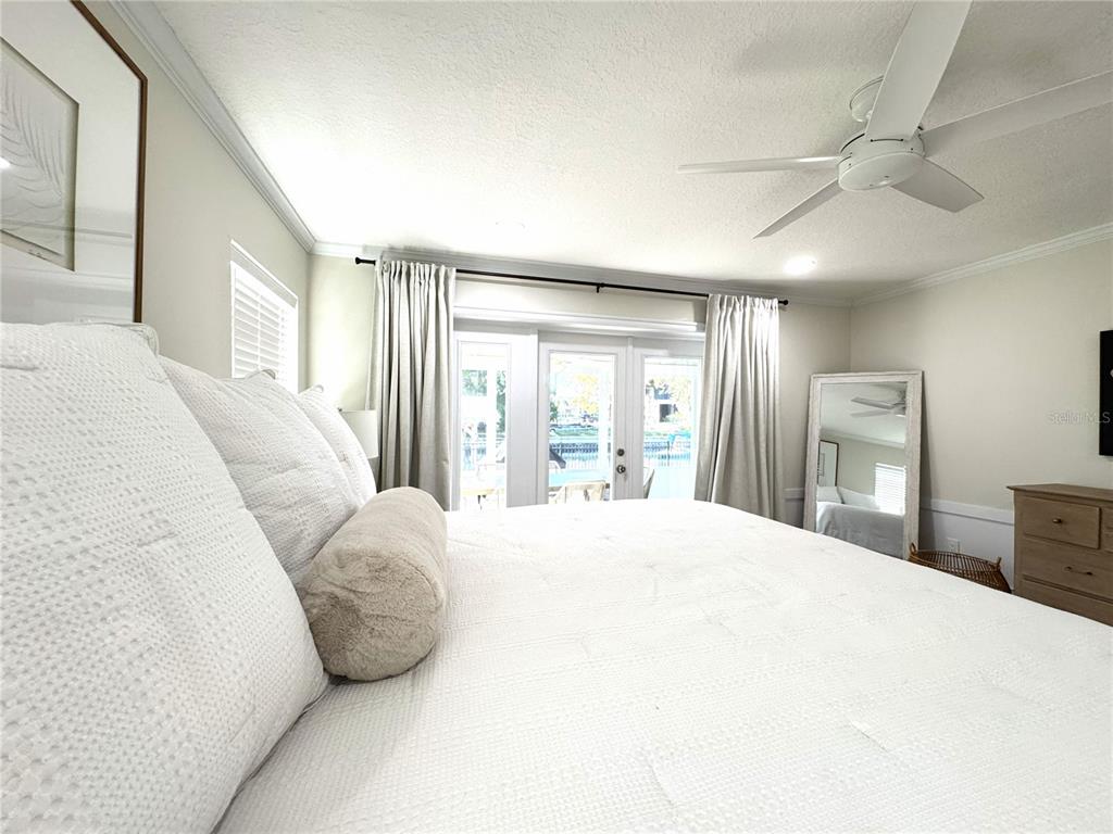 1004 Southeast 5th Avenue Crystal River, FL 34429 - Photo 21 of 43 a bedroom with a large bed and a large window