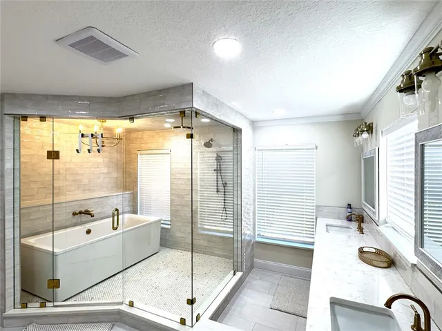 a bathroom with a tub mirror and window