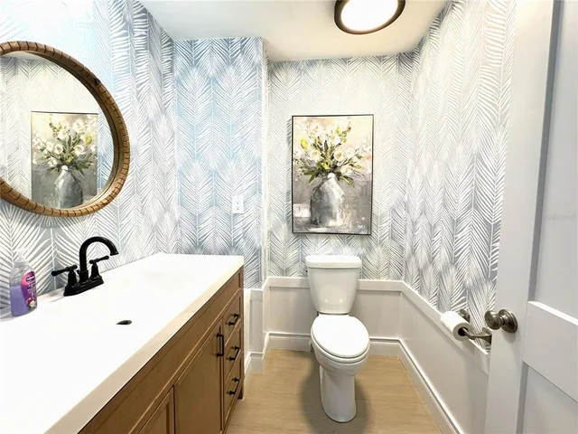 a bathroom with a toilet sink and mirror