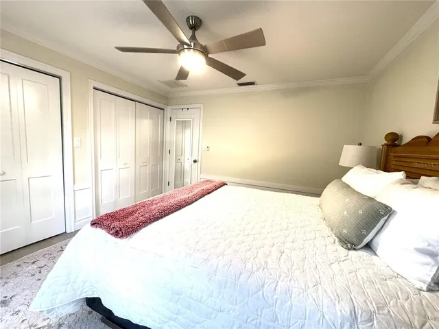 a bedroom with a large bed and a large window