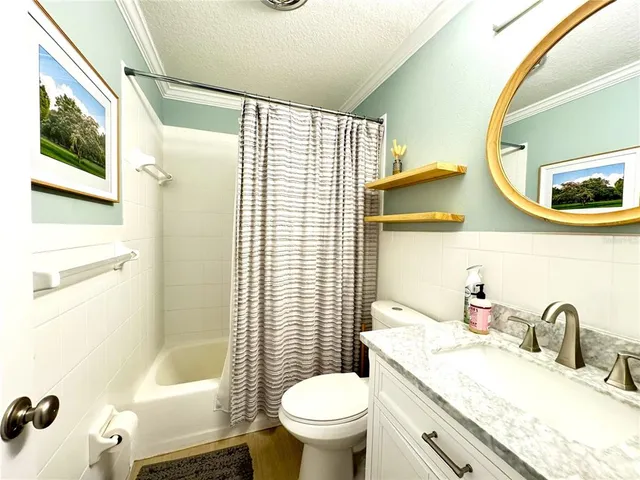 a bathroom with a granite countertop sink mirror vanity and toilet
