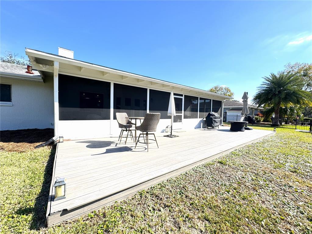 1004 Southeast 5th Avenue Crystal River, FL 34429 - Photo 40 of 43 a view of a patio with dining table and chairs with wooden floor